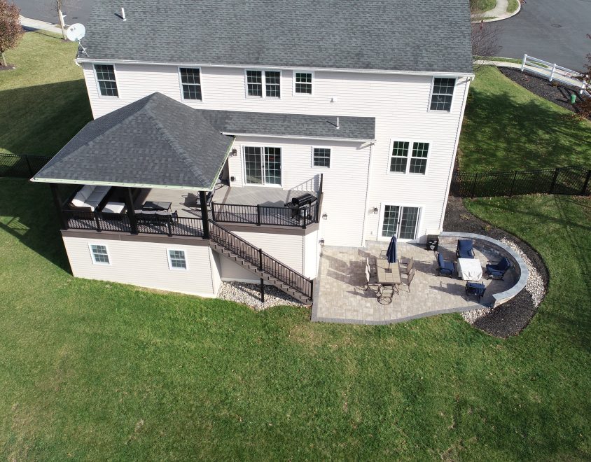 large white home with backyard porch and dining area