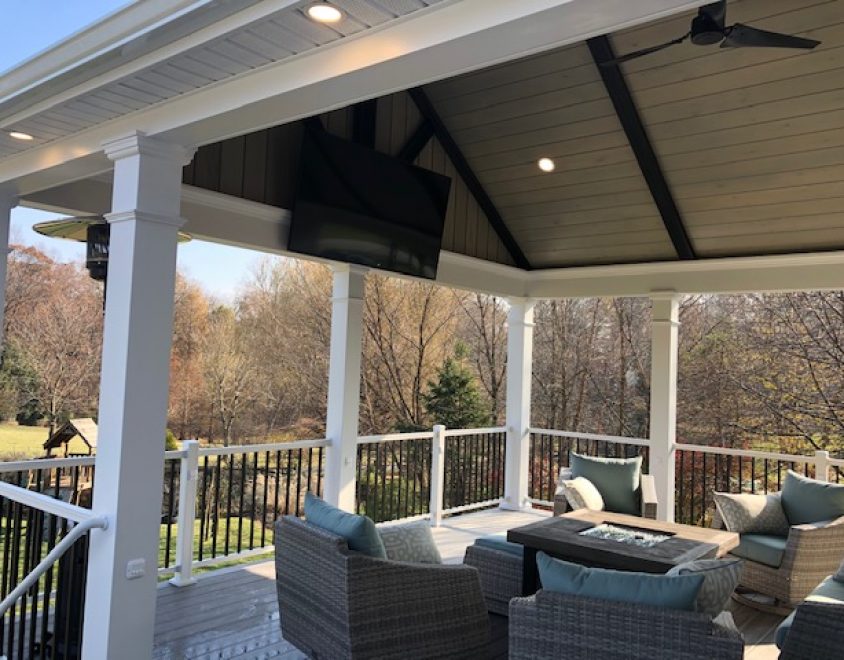 backyard porch with outdoor furniture and white porch columns