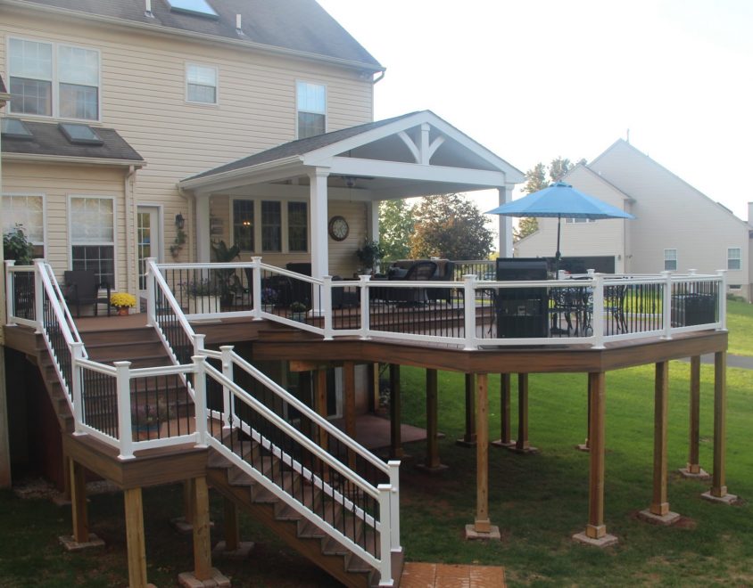 custom backyard deck with white vinyl handrails