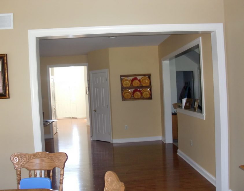 interior living space with brown hardwood floor and tan painted walls