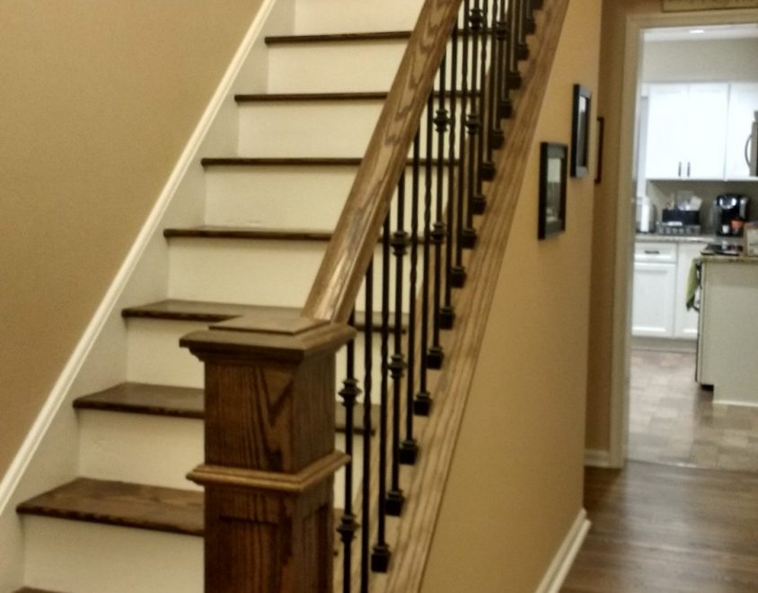 newly built white staircase with wood handrail